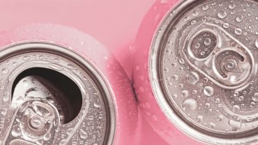 duas Latas de Blissful de cor rosa com gotas de água, vista superior