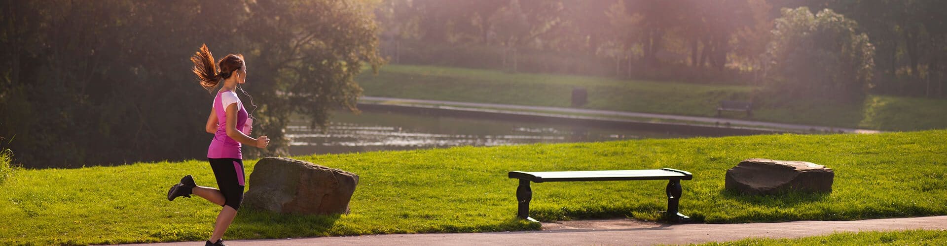 Mulher correndo em um parque.